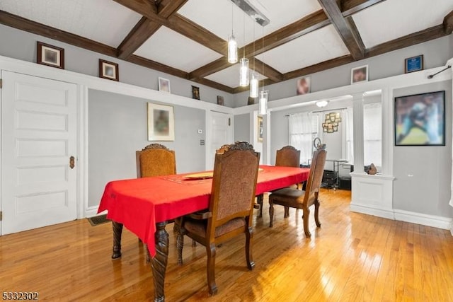 dining space featuring coffered ceiling, hardwood / wood-style floors, decorative columns, and beam ceiling