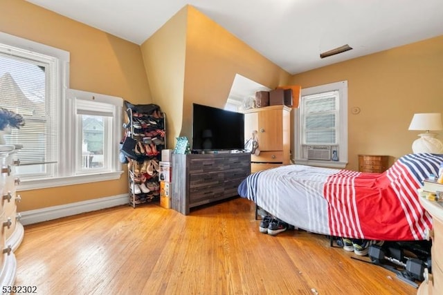 bedroom with light hardwood / wood-style flooring and cooling unit