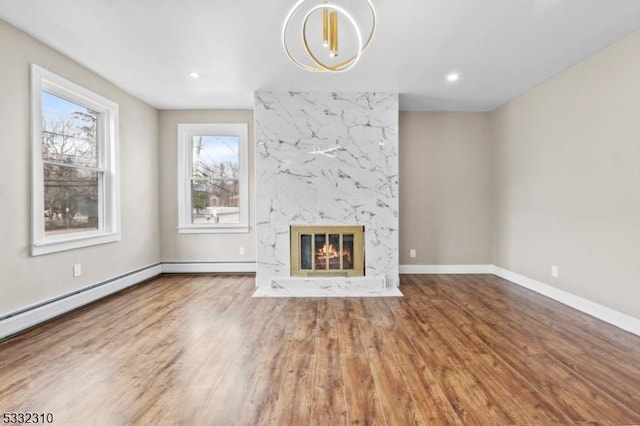 unfurnished living room with a fireplace and hardwood / wood-style floors