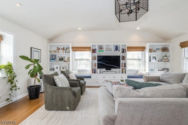 living room with vaulted ceiling and light hardwood / wood-style floors