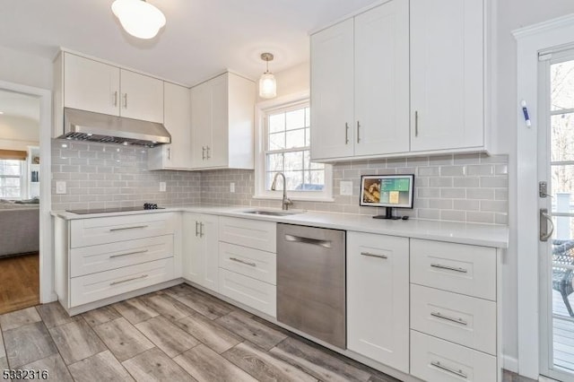 kitchen featuring white cabinetry, dishwasher, sink, hanging light fixtures, and black electric cooktop