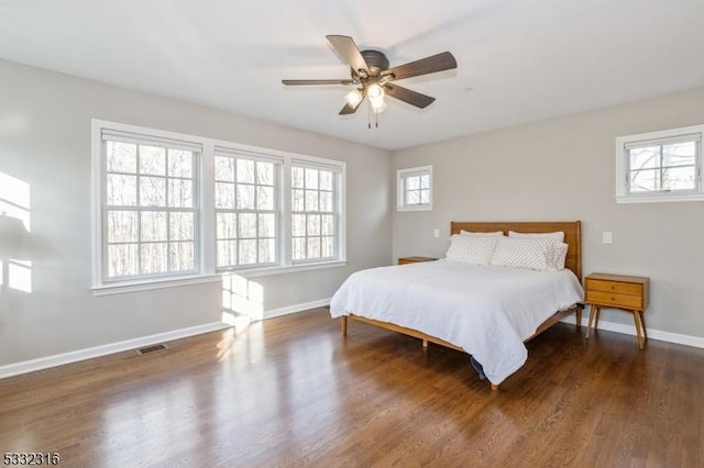 bedroom with dark wood-type flooring and ceiling fan