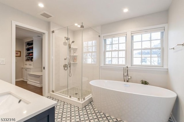 bathroom with vanity and independent shower and bath