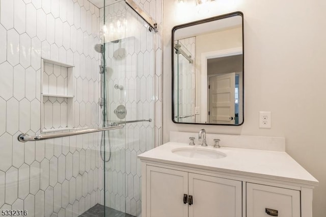 bathroom featuring an enclosed shower and vanity