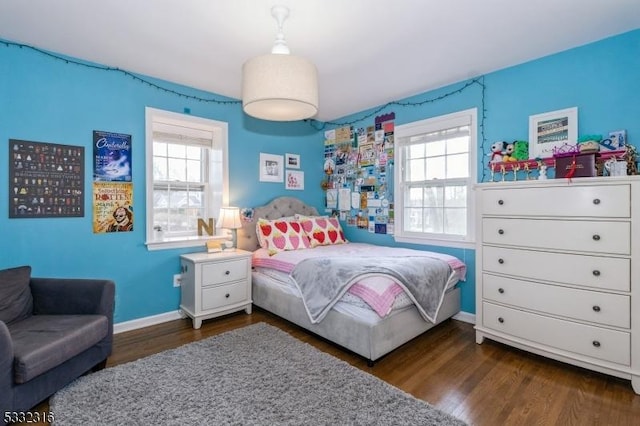 bedroom featuring dark hardwood / wood-style flooring and multiple windows