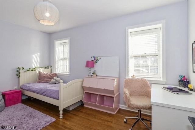 bedroom with dark wood-type flooring