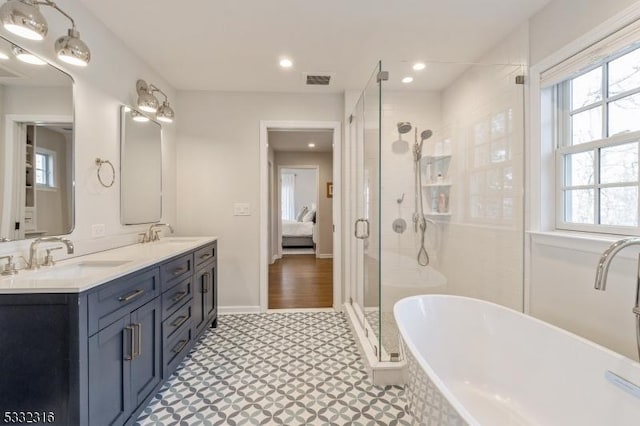 bathroom featuring vanity, plenty of natural light, and separate shower and tub