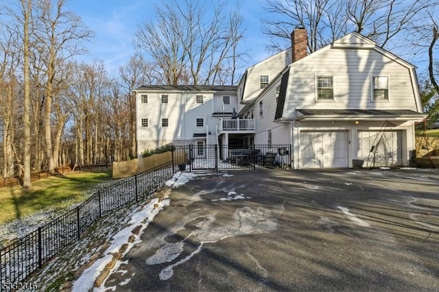 rear view of house featuring a garage