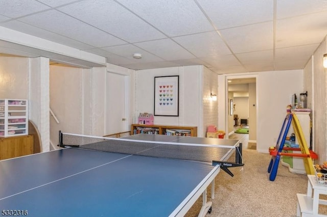 playroom with a paneled ceiling and carpet flooring