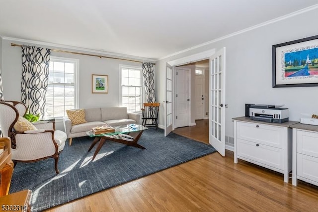 living room featuring french doors, wood-type flooring, and crown molding