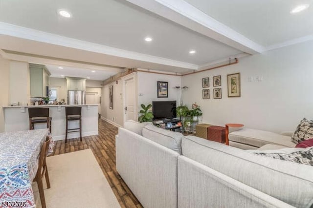 living room with ornamental molding, dark hardwood / wood-style floors, and beamed ceiling