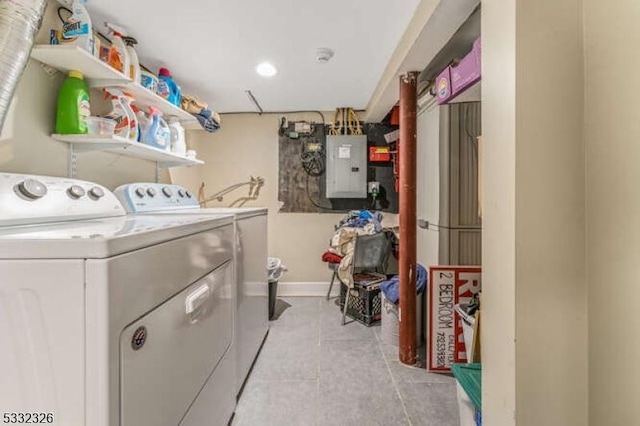 washroom with light tile patterned floors, electric panel, and washing machine and dryer