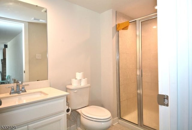 bathroom featuring a shower with shower door, toilet, and vanity