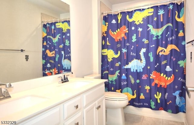 bathroom featuring toilet, vanity, tile patterned flooring, and a shower with curtain