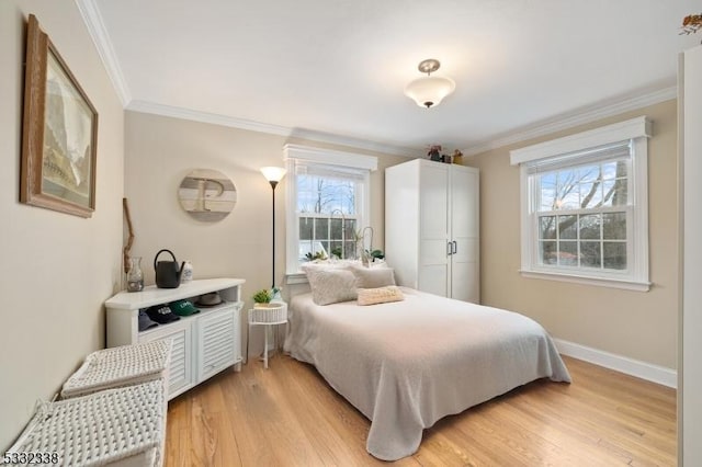 bedroom with ornamental molding and light hardwood / wood-style floors