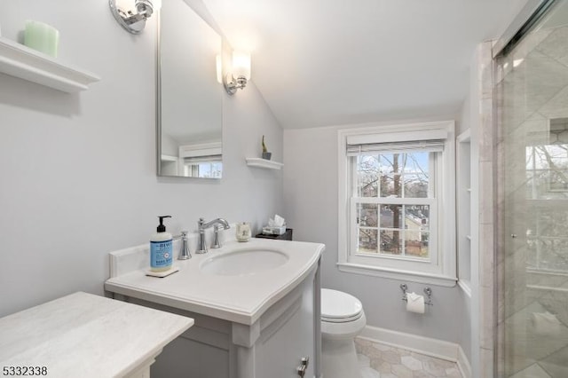 bathroom featuring toilet, tile patterned floors, a shower with shower door, and vanity