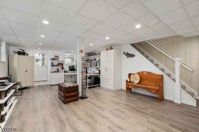 interior space with light hardwood / wood-style floors and a paneled ceiling