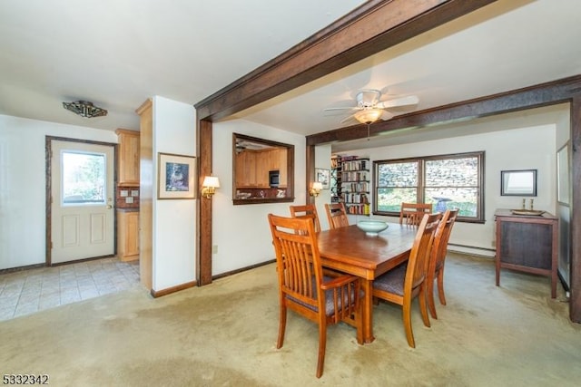 carpeted dining room with a baseboard heating unit, ceiling fan, plenty of natural light, and beamed ceiling