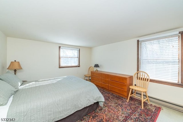 bedroom with carpet floors and a baseboard radiator