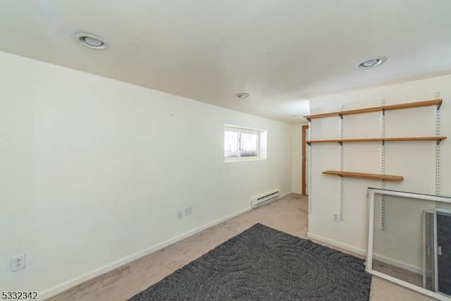 interior space featuring light carpet and a baseboard heating unit