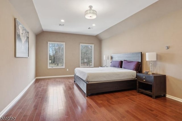 bedroom featuring hardwood / wood-style flooring and vaulted ceiling