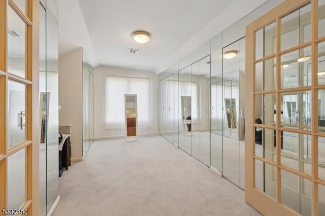 hallway with light colored carpet