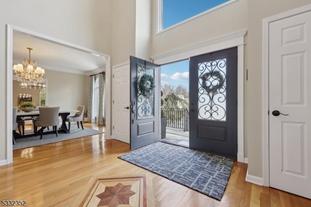 foyer featuring an inviting chandelier and hardwood / wood-style floors