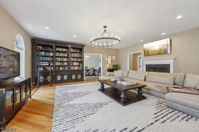 living room featuring an inviting chandelier and light hardwood / wood-style floors