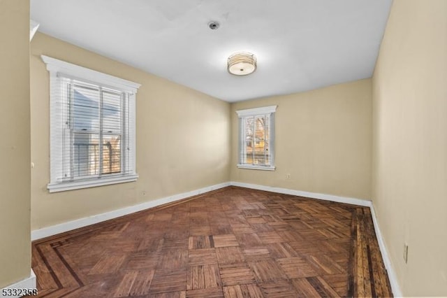 unfurnished room featuring dark parquet flooring