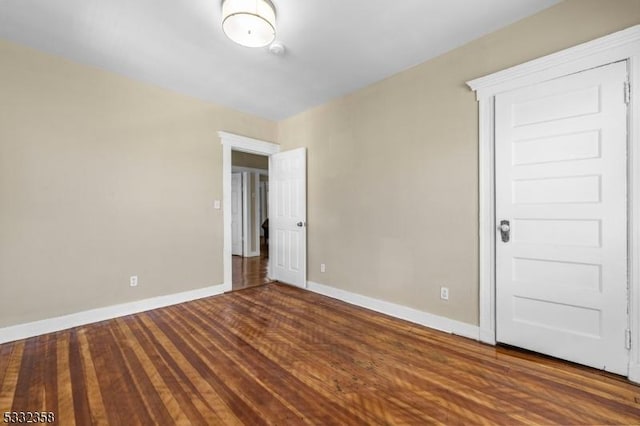 unfurnished room featuring dark hardwood / wood-style flooring