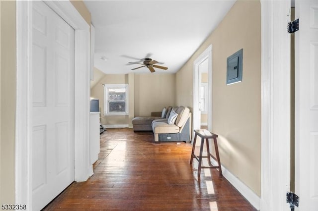 living room featuring ceiling fan and dark hardwood / wood-style floors