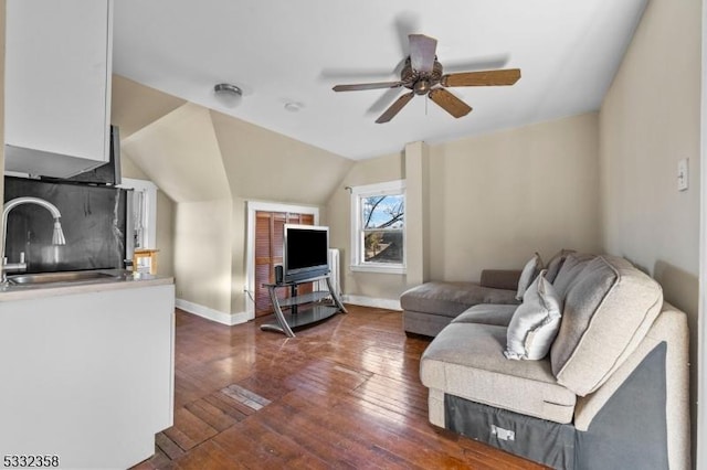 living room with ceiling fan, sink, dark hardwood / wood-style floors, and lofted ceiling