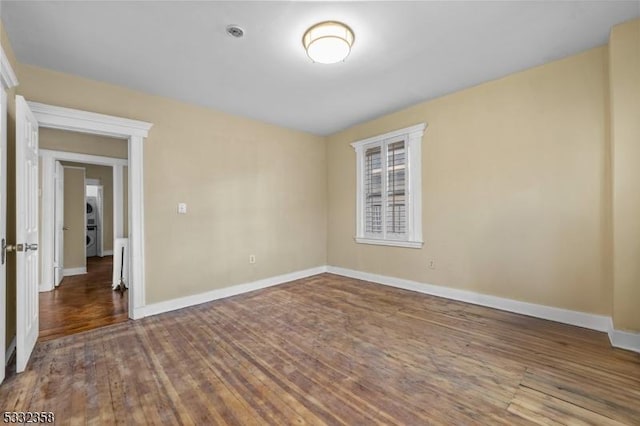 unfurnished room with dark hardwood / wood-style flooring