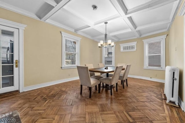 dining space with coffered ceiling, a notable chandelier, radiator, dark parquet flooring, and beamed ceiling