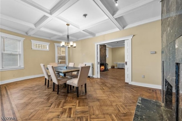 dining area with crown molding, radiator, parquet floors, and a fireplace