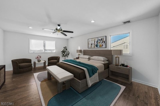 bedroom with dark wood-type flooring, ceiling fan, and multiple windows