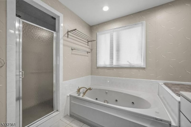 bathroom featuring tile patterned flooring, shower with separate bathtub, and vanity