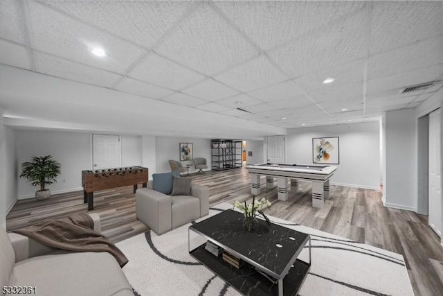 living room with pool table, hardwood / wood-style floors, and a drop ceiling