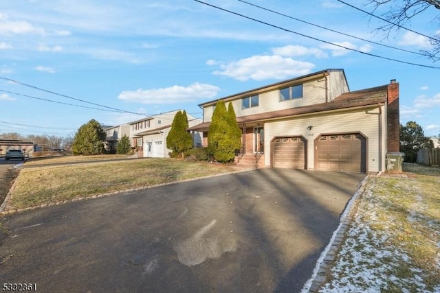 front facade with a front yard and a garage