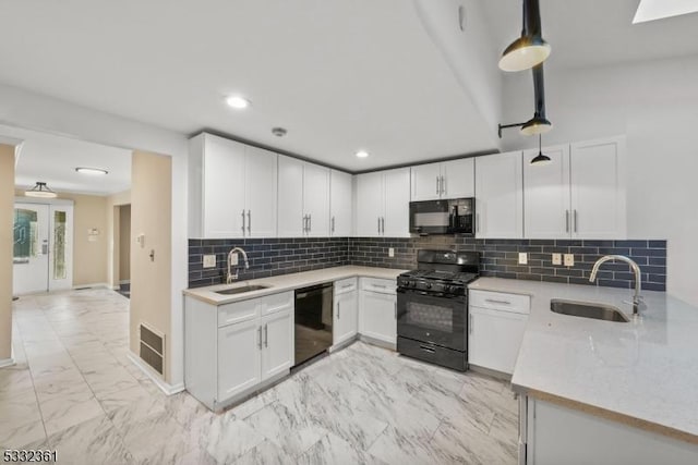 kitchen featuring black appliances, hanging light fixtures, white cabinets, and sink