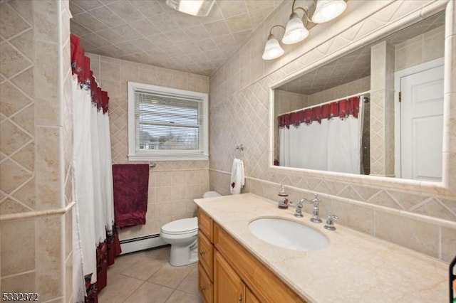 bathroom with tile walls, toilet, tile patterned floors, a baseboard radiator, and vanity