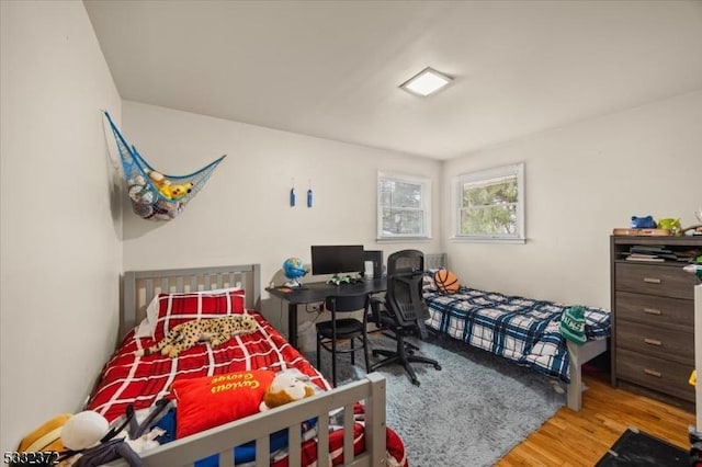 bedroom with hardwood / wood-style flooring