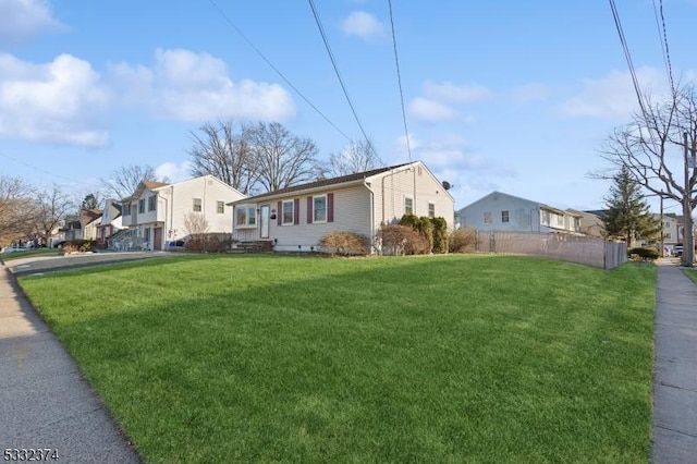 view of side of property featuring a yard