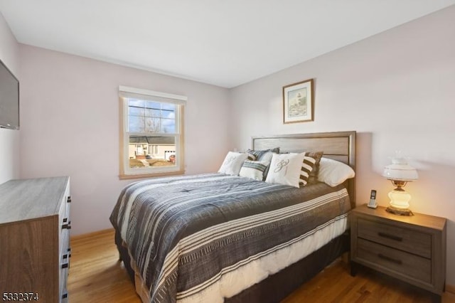 bedroom with dark hardwood / wood-style floors