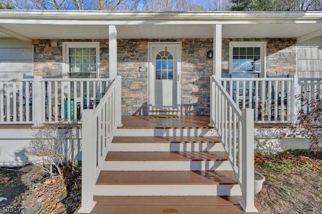 view of exterior entry with a porch