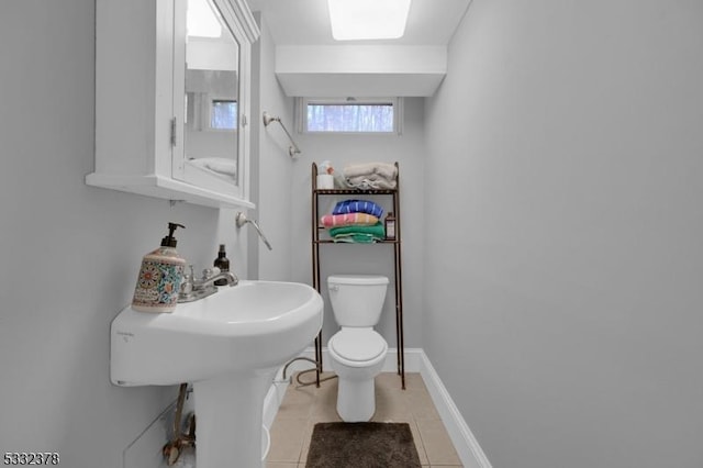 bathroom with toilet and tile patterned floors