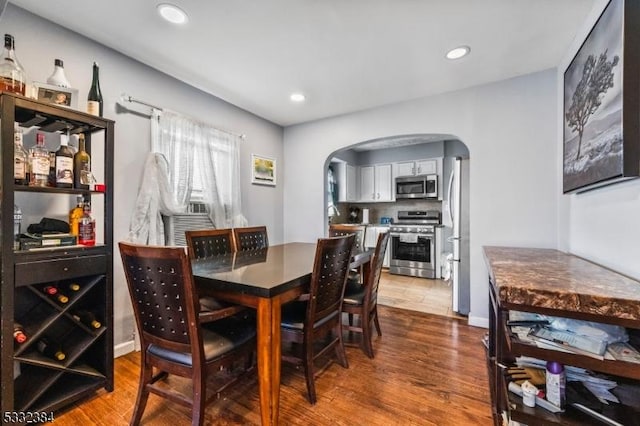 dining space with hardwood / wood-style floors