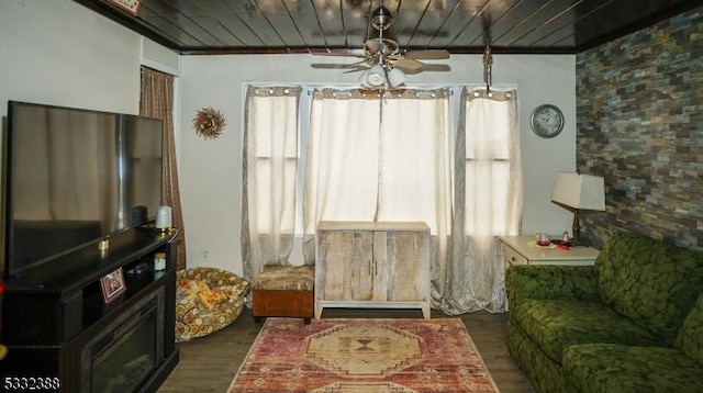 living room with ceiling fan, a healthy amount of sunlight, and wooden ceiling