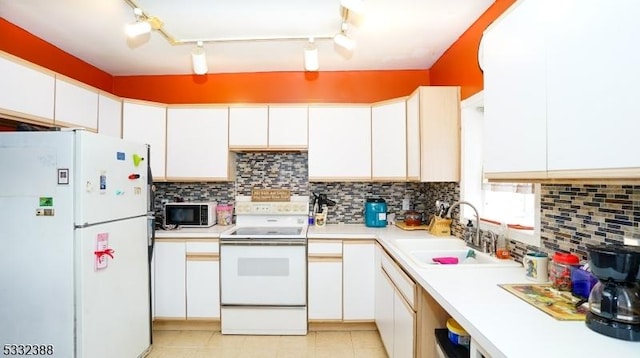 kitchen featuring white cabinets, white appliances, track lighting, and sink