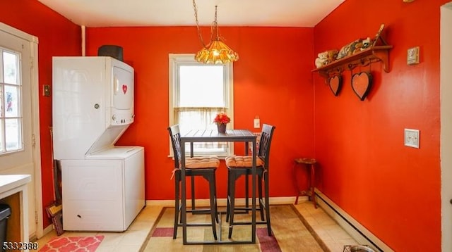 interior space with a chandelier, stacked washer and dryer, and a baseboard radiator